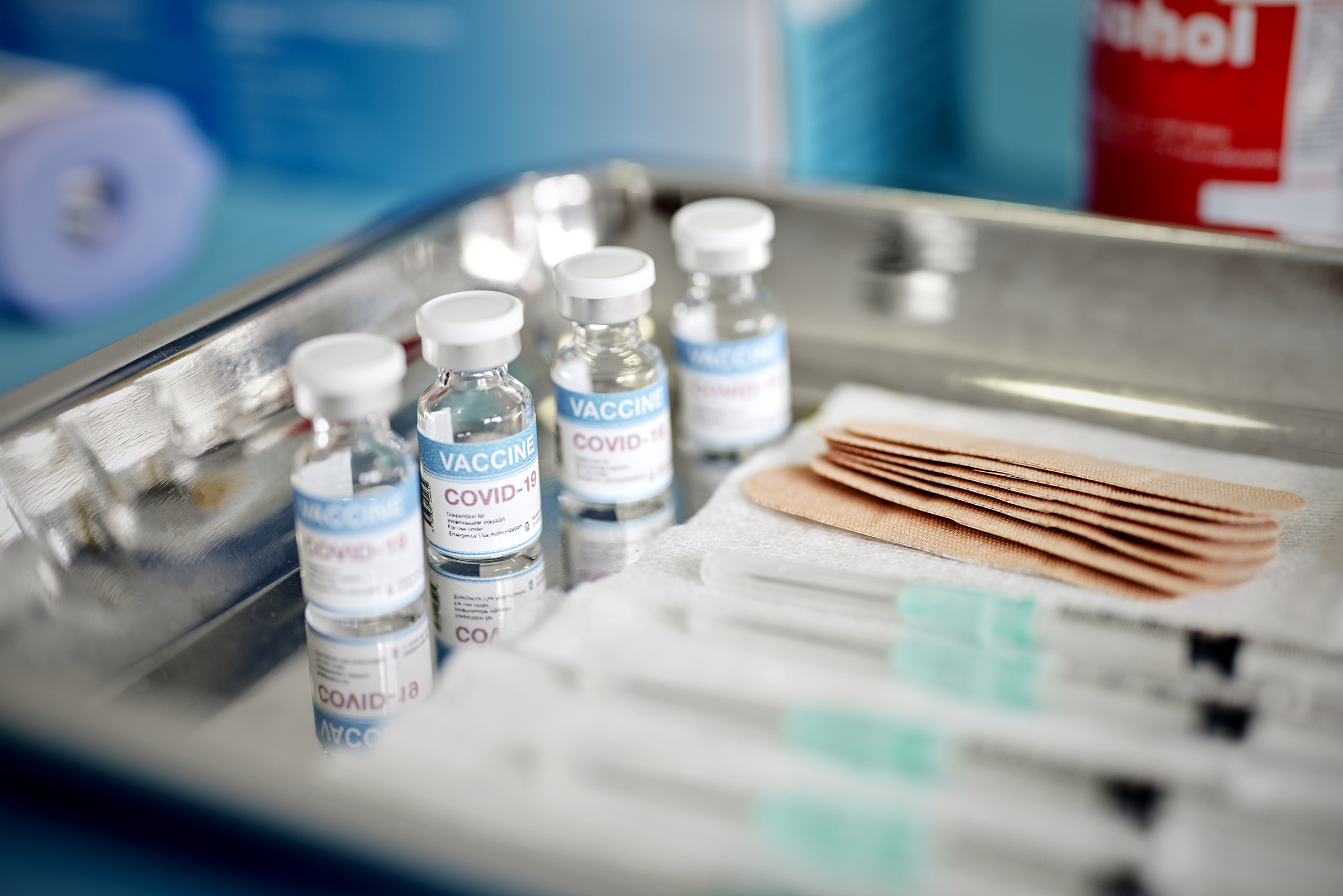 Close up of Vials and Syringes with Covid-19 vaccine are displayed on a tray during vaccination.